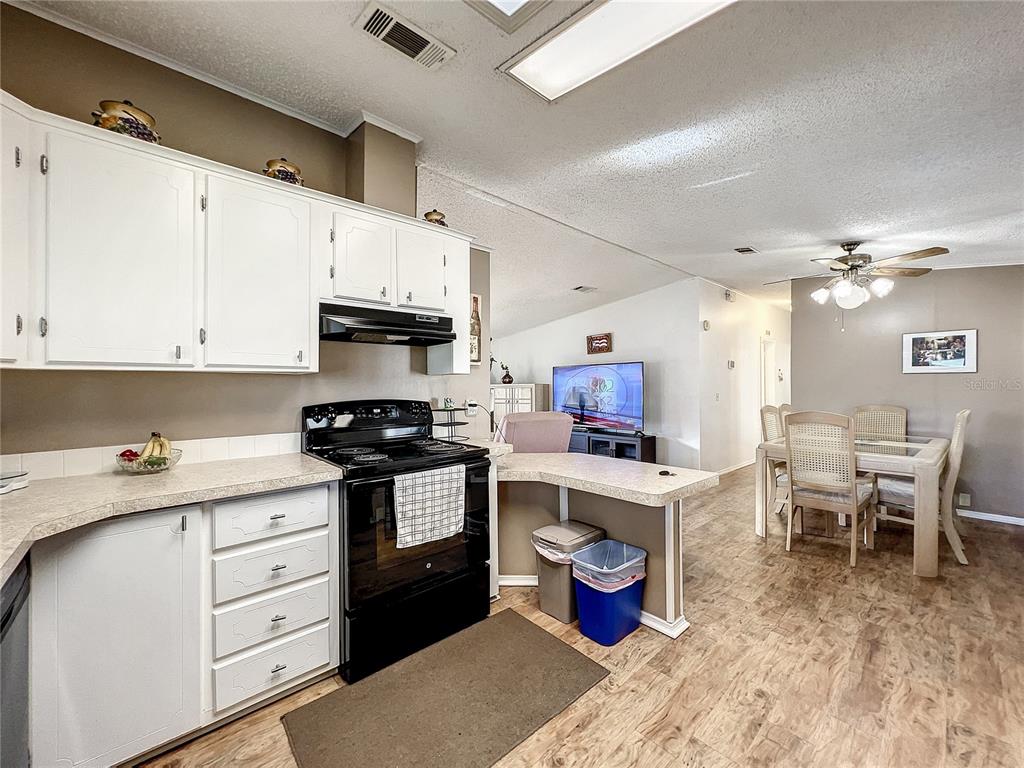 6518 Raintree Lane Winter Haven, FL 33881 - Photo 13 of 42 a kitchen with a stove and a refrigerator