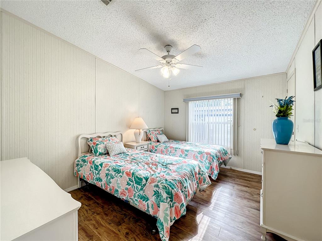 6518 Raintree Lane Winter Haven, FL 33881 - Photo 17 of 42 a bedroom with a bed and a chandelier