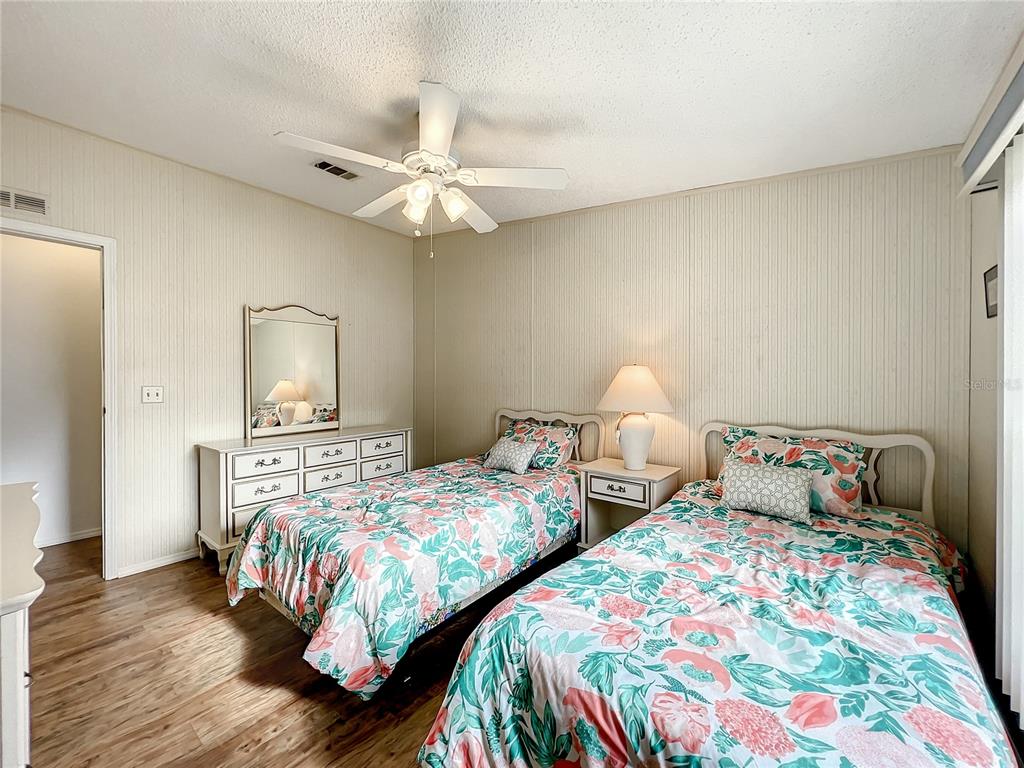 6518 Raintree Lane Winter Haven, FL 33881 - Photo 18 of 42 a bedroom with two beds and a chandelier