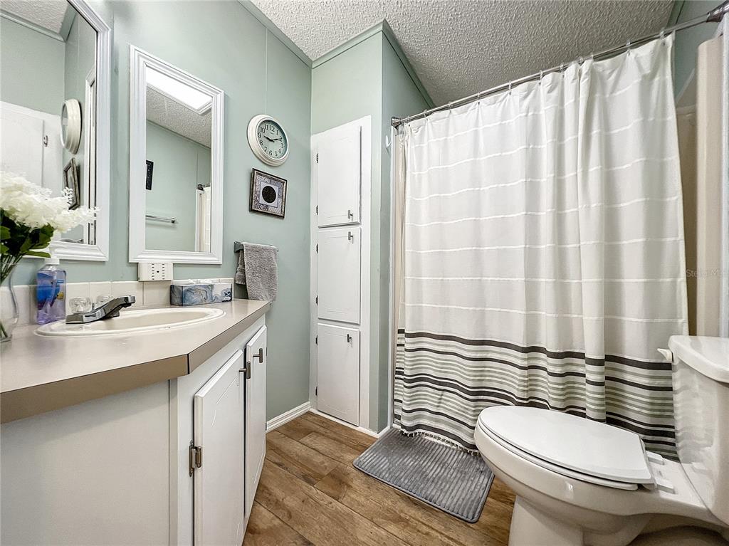 6518 Raintree Lane Winter Haven, FL 33881 - Photo 20 of 42 a bathroom with a sink a toilet a mirror a vanity and shower