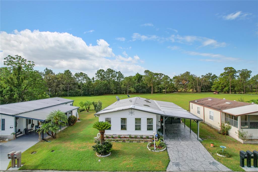 6518 Raintree Lane Winter Haven, FL 33881 - Photo 2 of 42 a aerial view of a house with yard patio and green space