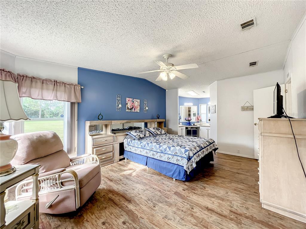 6518 Raintree Lane Winter Haven, FL 33881 - Photo 23 of 42 a living room with furniture and a flat screen tv