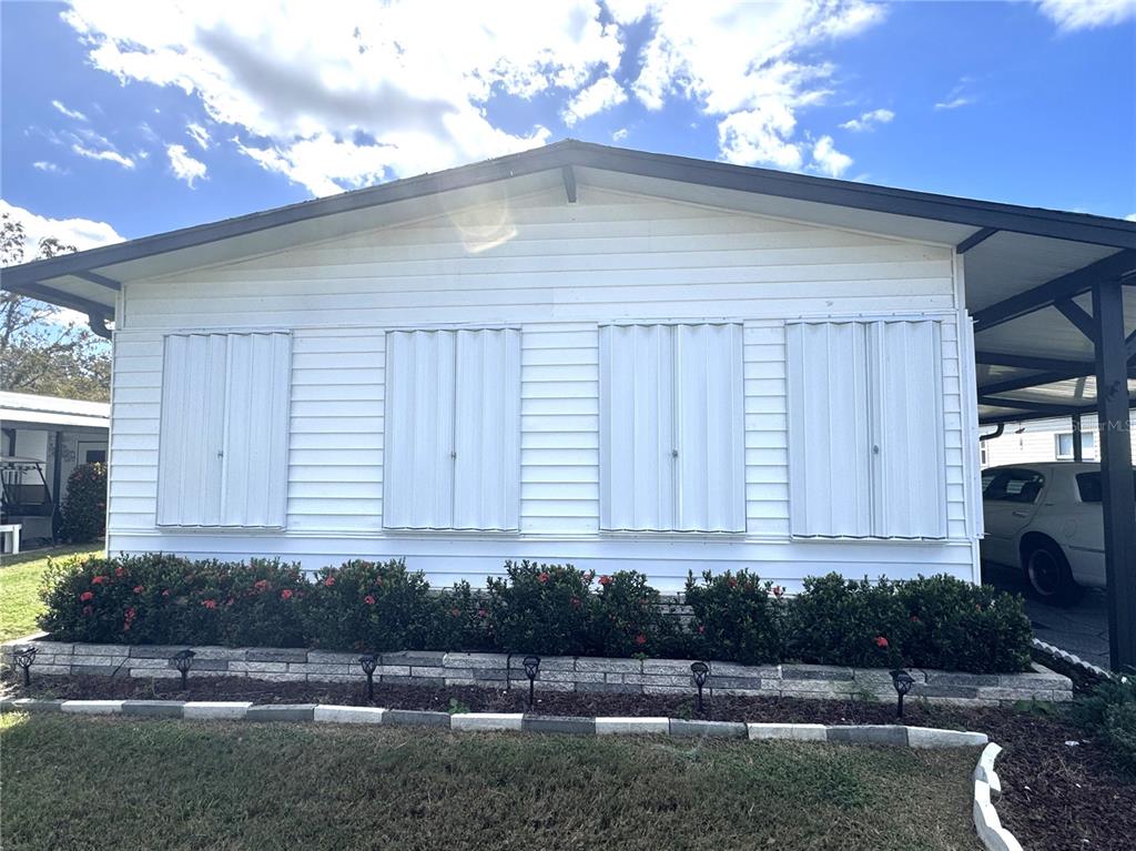 6518 Raintree Lane Winter Haven, FL 33881 - Photo 31 of 42 a front view of a house with a yard