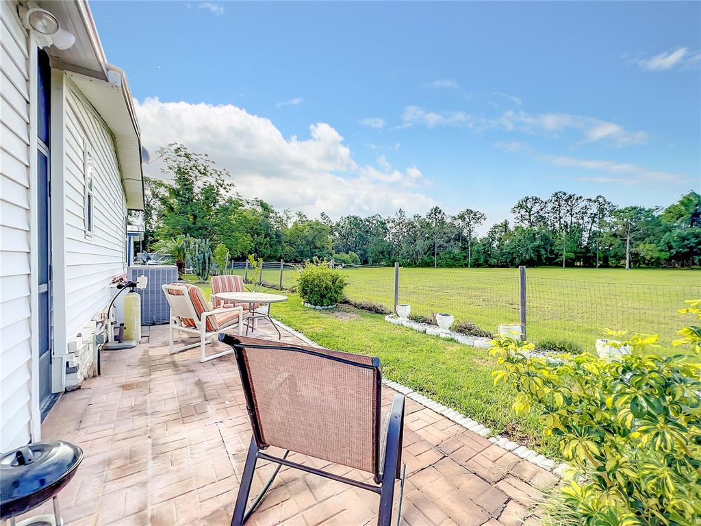 6518 Raintree Lane Winter Haven, FL 33881 - Photo 33 of 42 a backyard of a house with table and chairs