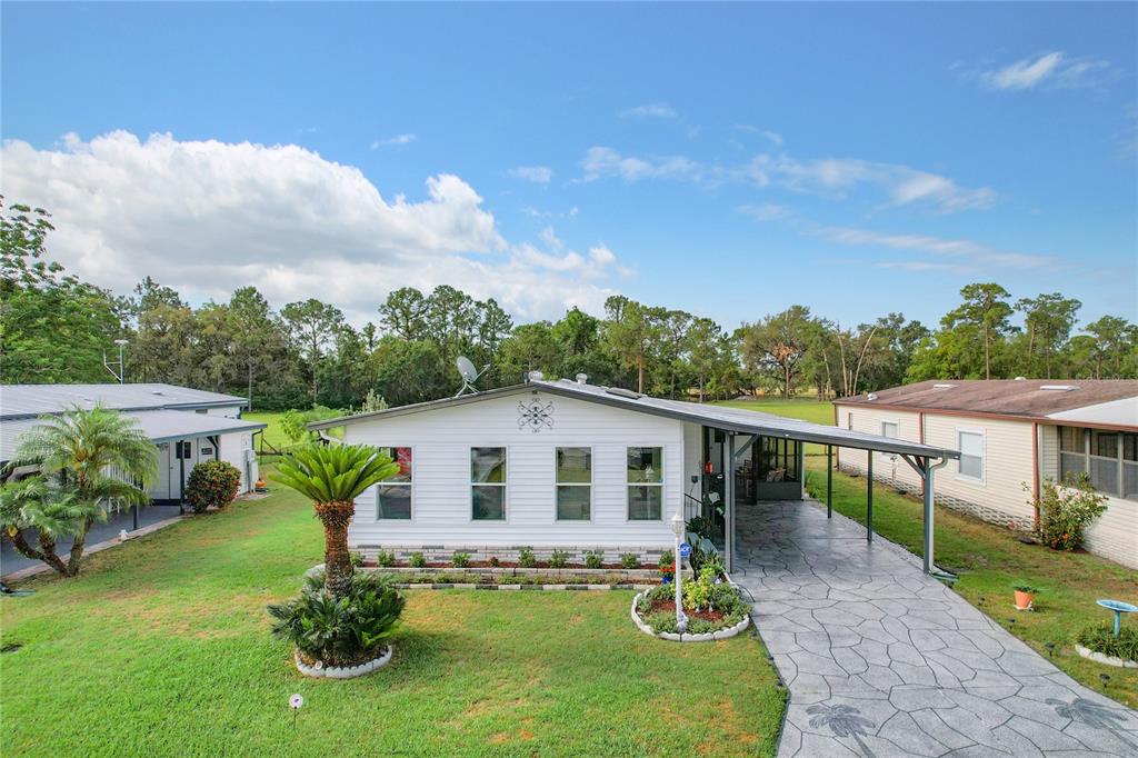 6518 Raintree Lane Winter Haven, FL 33881 - Photo 34 of 42 a house view with a garden space