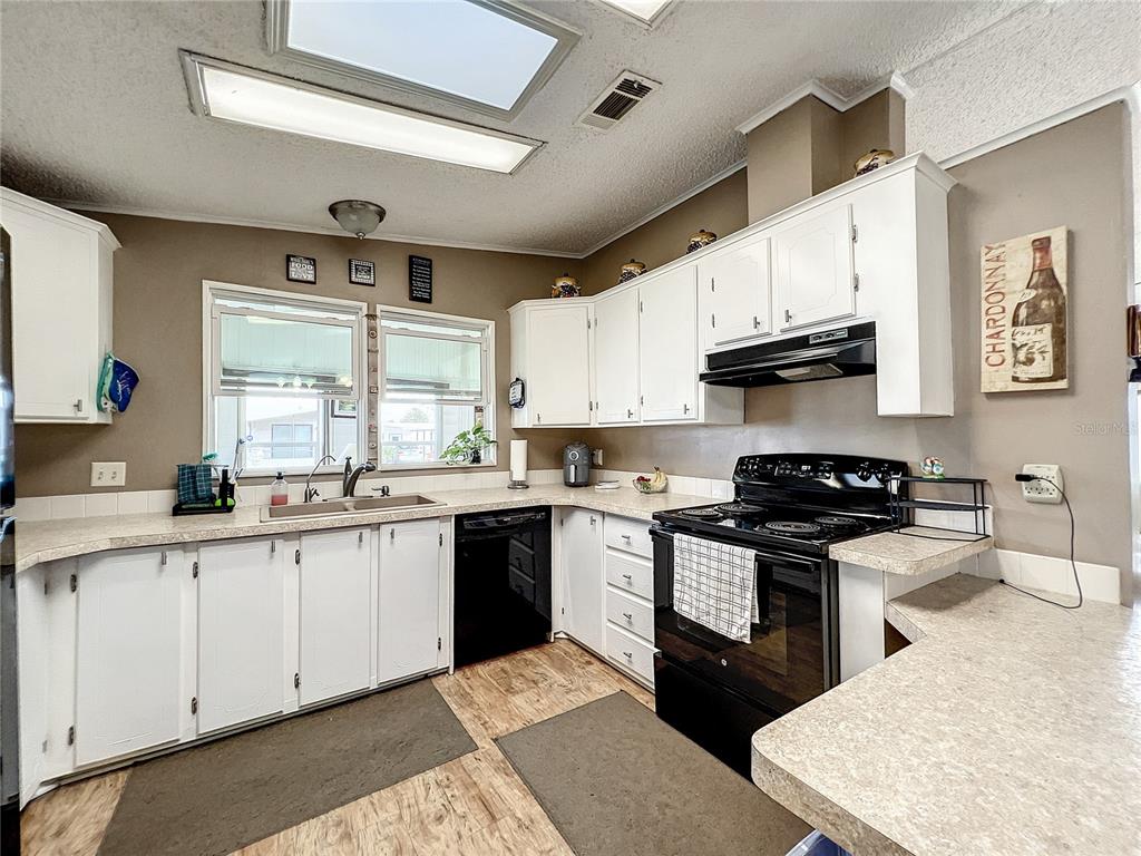 6518 Raintree Lane Winter Haven, FL 33881 - Photo 5 of 42 a kitchen with stainless steel appliances granite countertop a sink and stove top oven