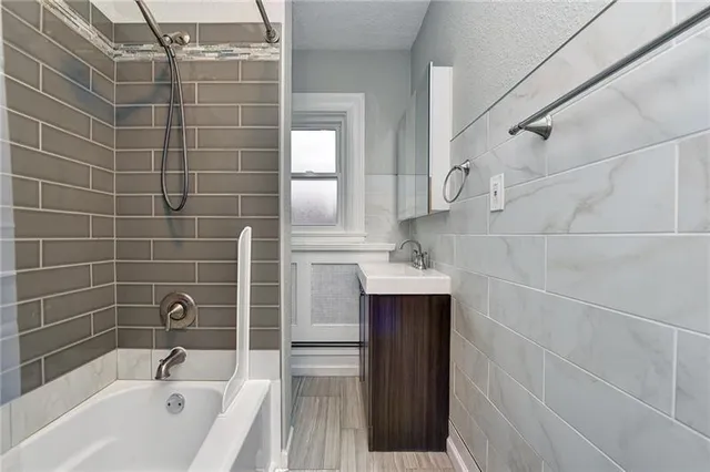 a bathroom with a bathtub and shower