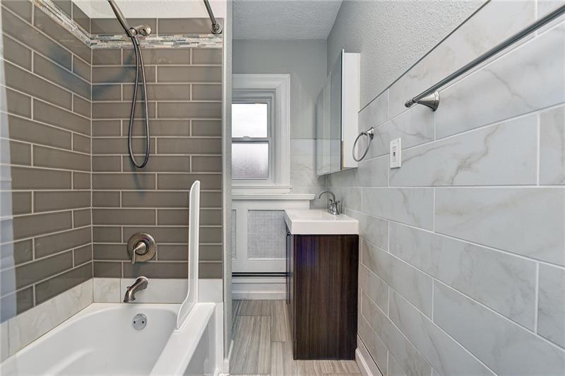 6316 Morrowfield Avenue, Unit 3 Pittsburgh, PA 15217 - Photo 11 of 14 a bathroom with a bathtub and shower