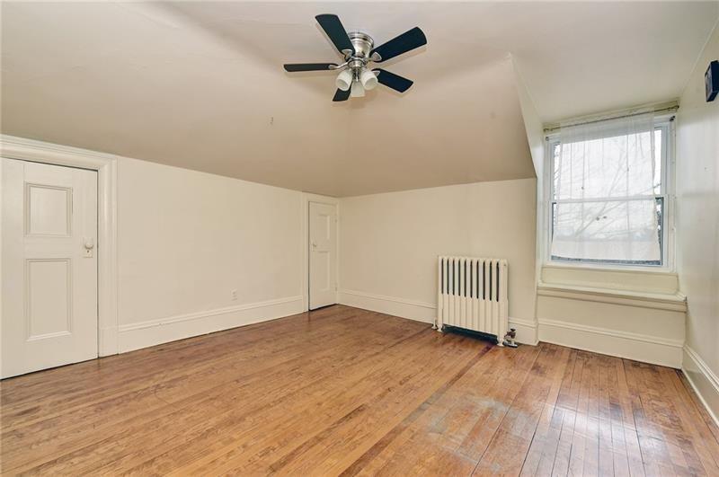 6316 Morrowfield Avenue, Unit 3 Pittsburgh, PA 15217 - Photo 6 of 14 wooden floor in an empty room with a window