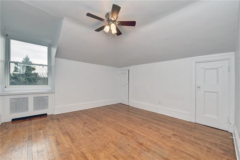 6316 Morrowfield Avenue, Unit 3 Pittsburgh, PA 15217 - Photo 7 of 14 wooden floor in an empty room with a window
