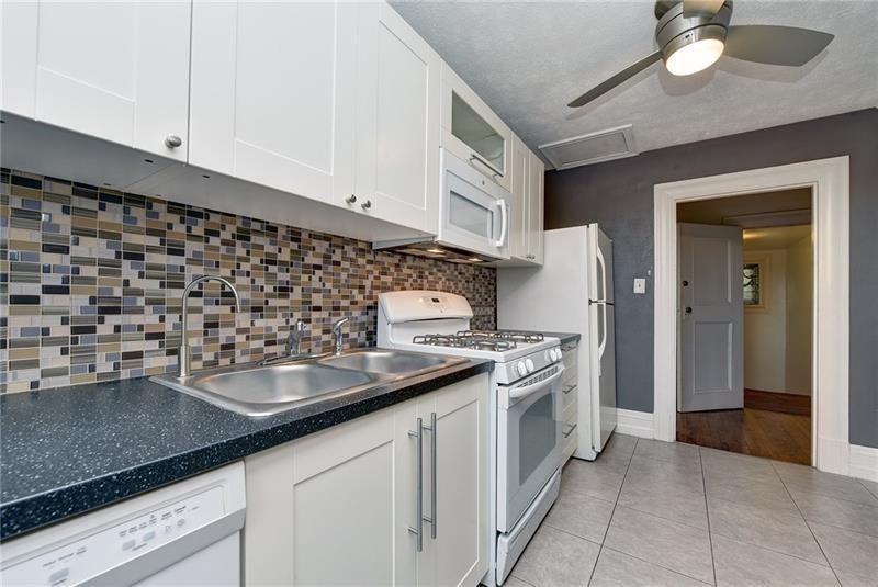 6316 Morrowfield Avenue, Unit 3 Pittsburgh, PA 15217 - Photo 10 of 14 a kitchen with a sink and cabinets