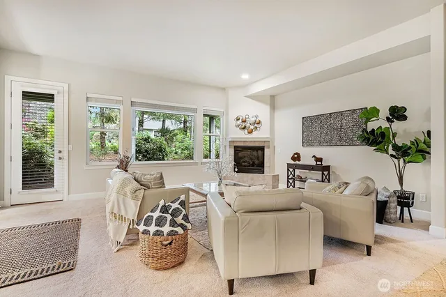 a living room with furniture large window and a fireplace