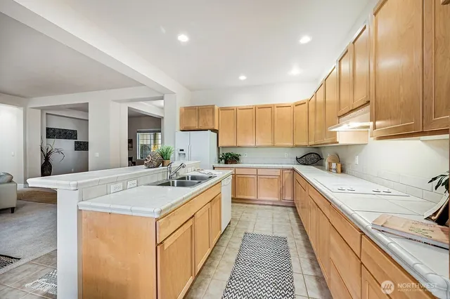 a kitchen with a sink stove and cabinets
