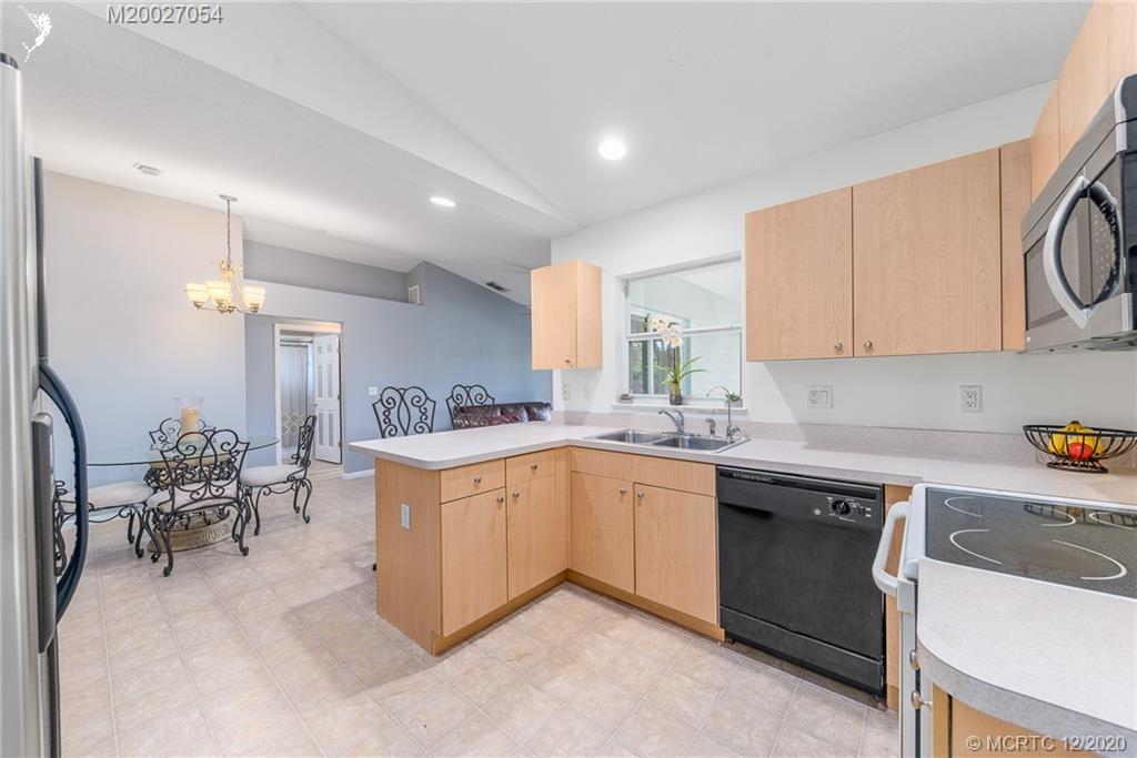 482 Southwest Homeland Road Port St. Lucie, FL 34953 - Photo 3 of 15 a kitchen with cabinets a sink and appliances