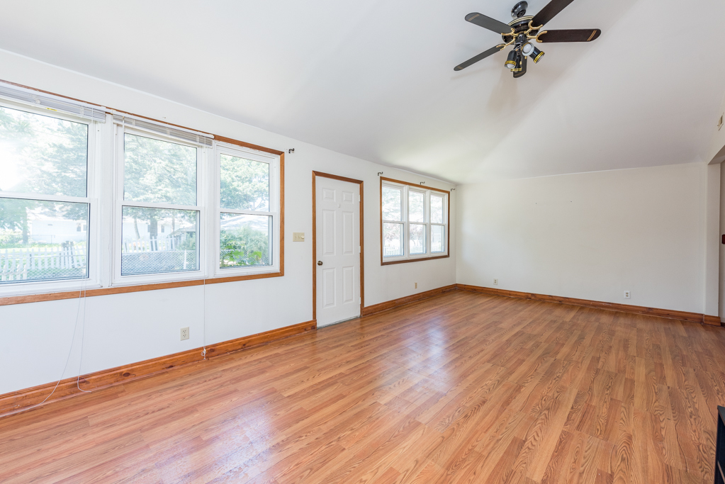 46 Tremont Road Fox Lake, IL 60020 - Photo 4 of 19 a view of empty room with wooden floor and fan