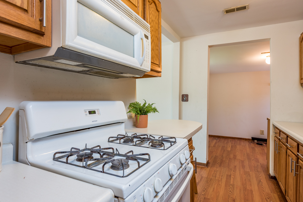 46 Tremont Road Fox Lake, IL 60020 - Photo 7 of 19 a kitchen with a stove and wooden floor