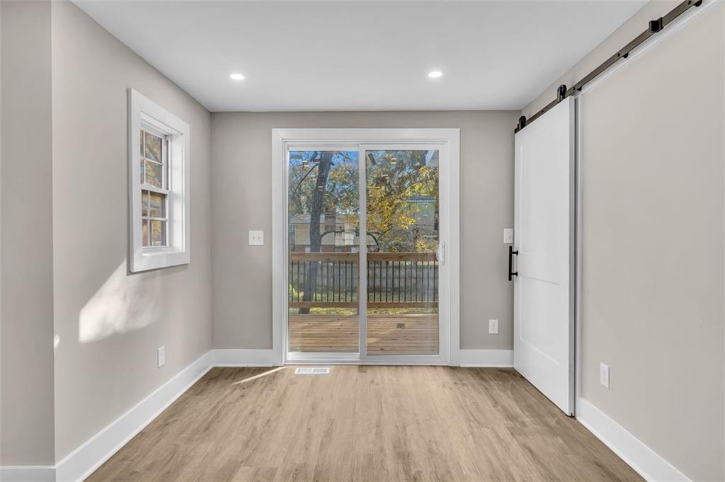 1874 Phillips Avenue East Point, GA 30344 - Photo 11 of 19 wooden floor in an empty room with a window