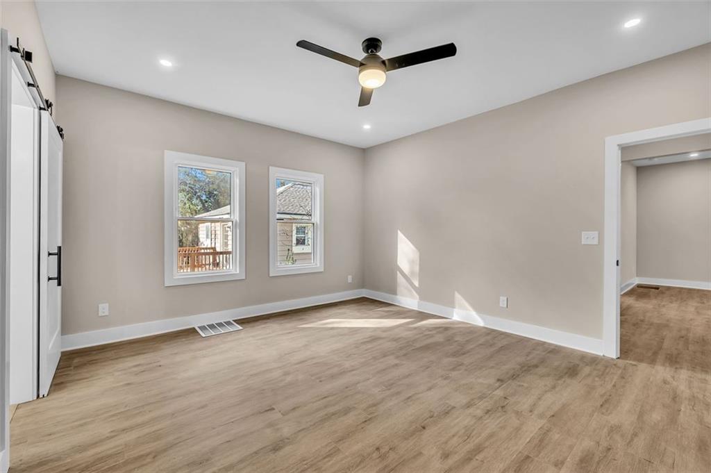 1874 Phillips Avenue East Point, GA 30344 - Photo 13 of 19 a view of an empty room with a window and wooden floor