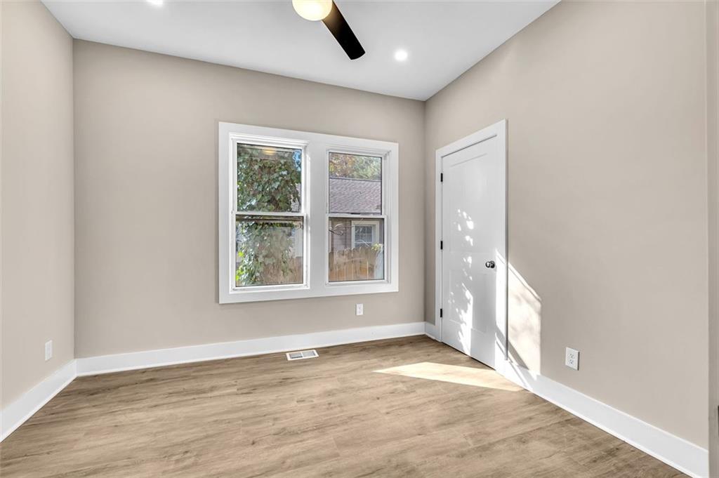 1874 Phillips Avenue East Point, GA 30344 - Photo 16 of 19 an empty room with wooden floor and windows