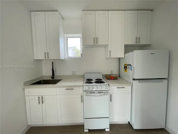 a kitchen with cabinets and white appliances