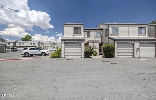 a view of a car park in front of house