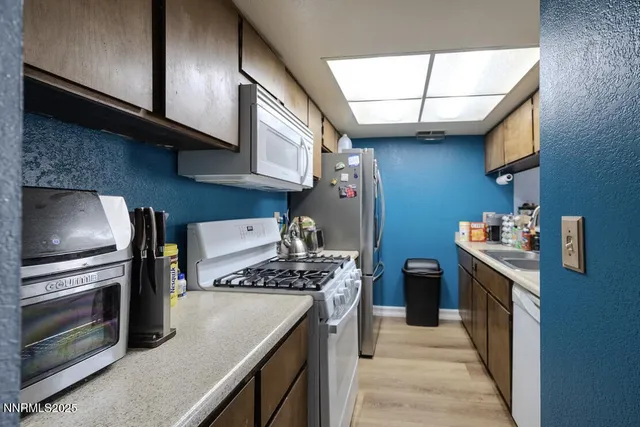 a kitchen with stainless steel appliances granite countertop a stove and a microwave