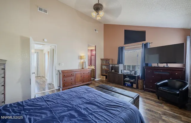 a bedroom with a bed and a flat screen tv