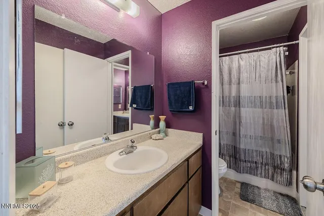 a bathroom with a sink mirror and shower