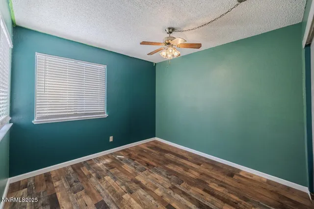 a view of a room with a fan and a window