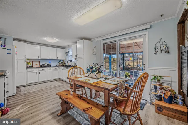 a kitchen with a table chairs stove and cabinets