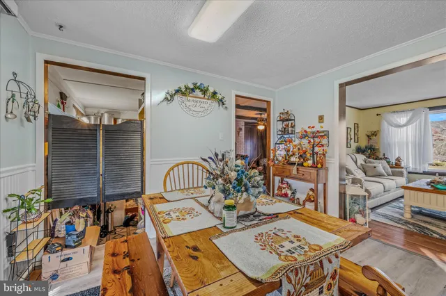a kitchen with stainless steel appliances white cabinets and wooden floors