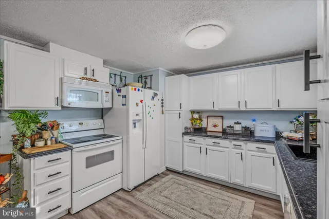 a kitchen with white cabinets sink and white appliances