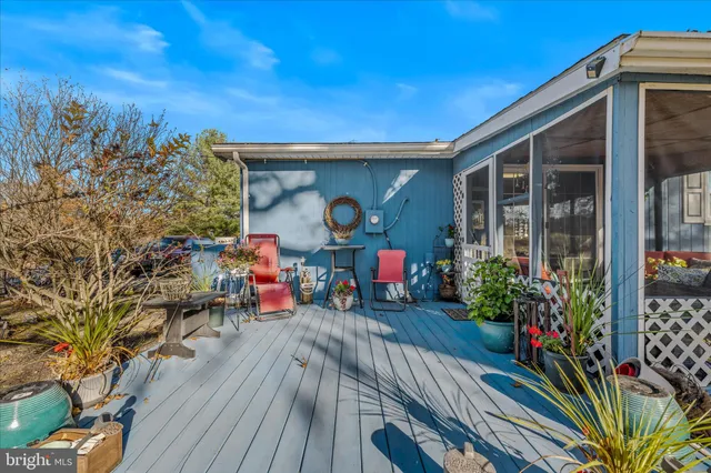 a bedroom with a bed and large windows