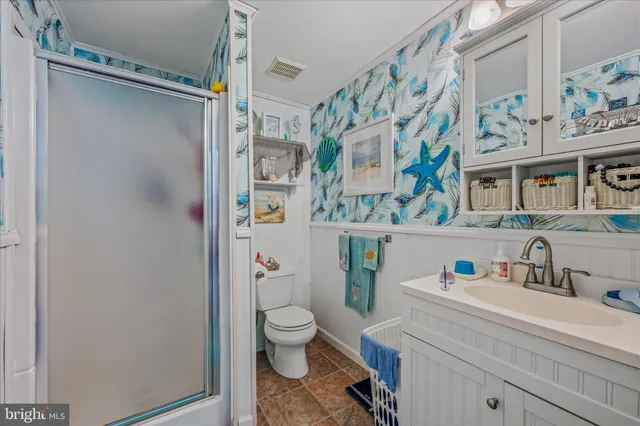 a bedroom with a bed and a flat tv screen on dresser