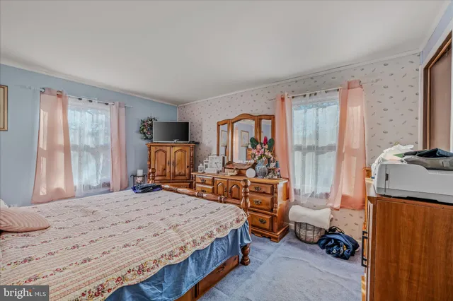 a bedroom with a large bed and a dresser