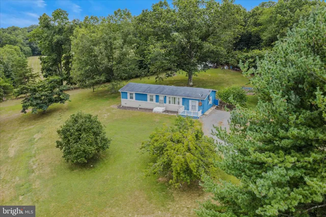 a view of a house with pool and a yard