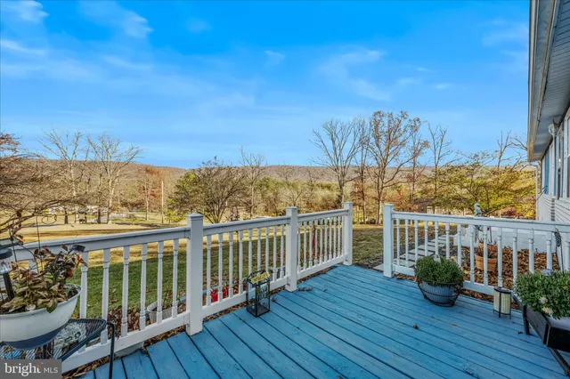 a view of a balcony with wooden floor space and iron fence