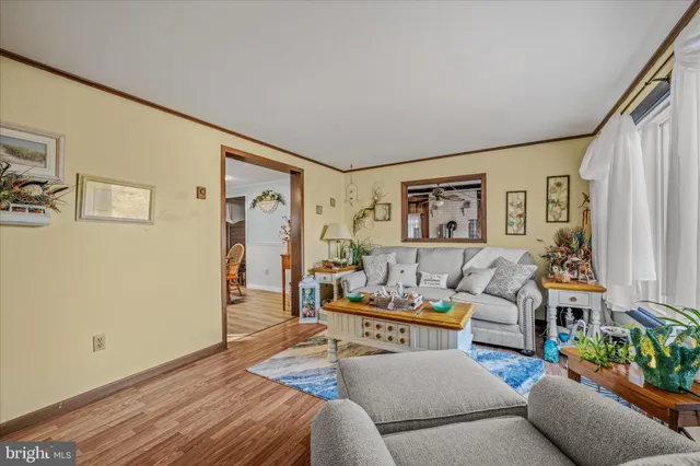 a living room with furniture and painting on the wall