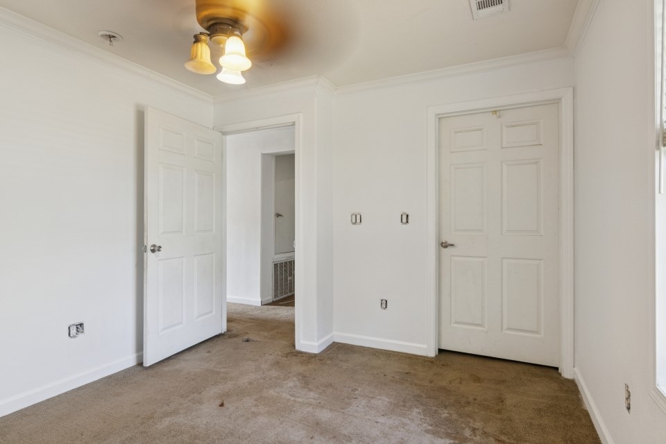 4619 2nd Street Bacliff, TX 77518 - Photo 14 of 24 an empty room with a chandelier fan and closet