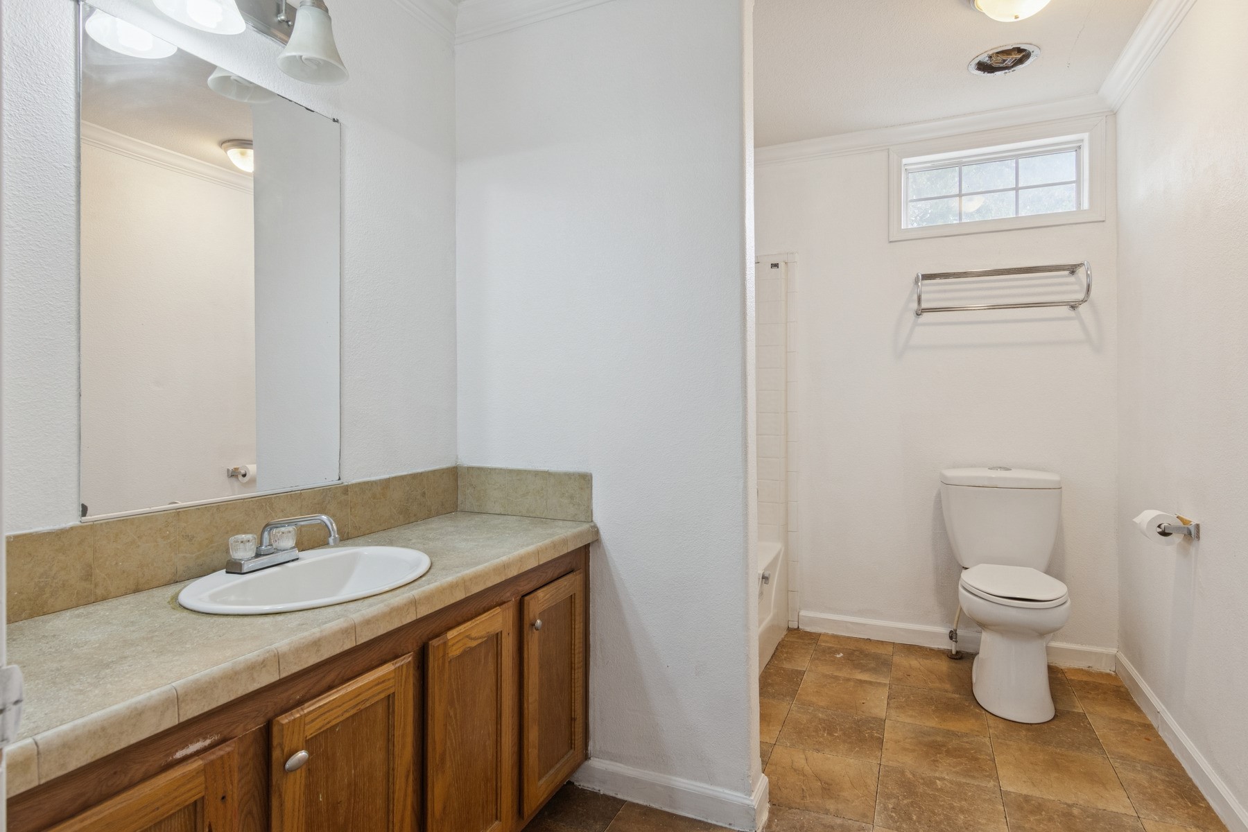 4619 2nd Street Bacliff, TX 77518 - Photo 17 of 24 a bathroom with a granite countertop sink toilet and a mirror