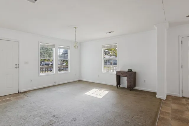 a view of kitchen with furniture and refrigerator