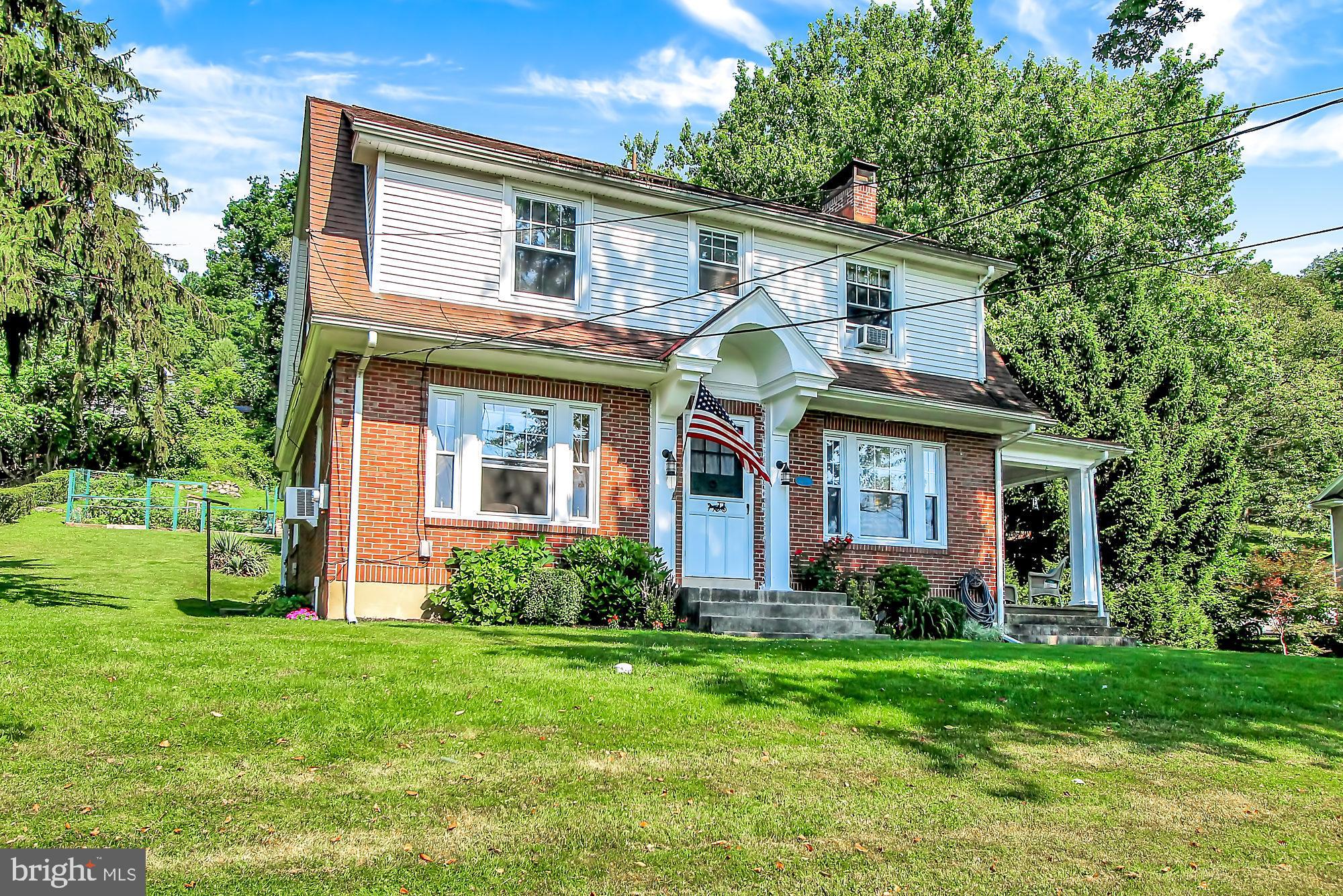 1704 Friedensburg Road Reading, PA 19606 - Photo 23 of 25 a view of a house with brick walls and a yard with plants