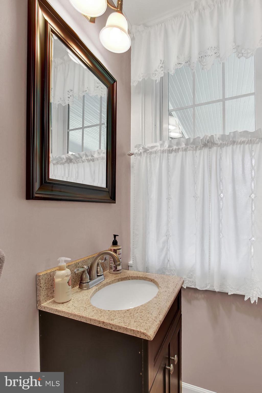 1704 Friedensburg Road Reading, PA 19606 - Photo 9 of 25 a bathroom with a granite countertop sink and a mirror