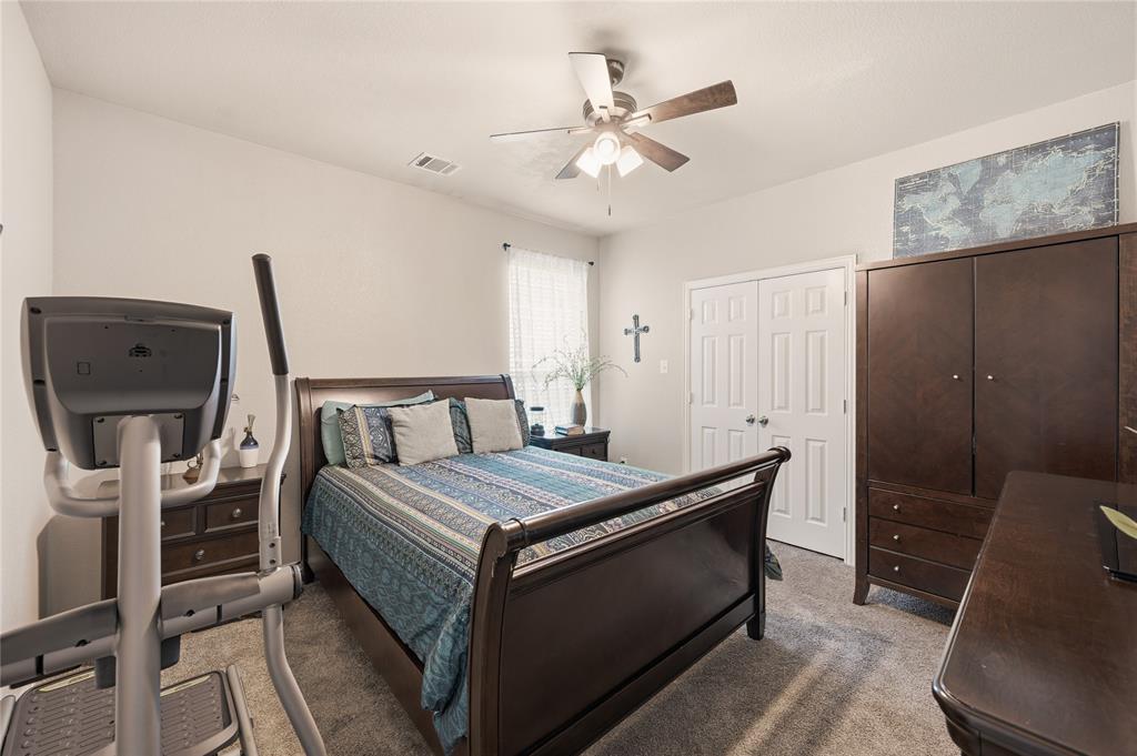 140 Chestnut Road Waxahachie, TX 75165 - Photo 22 of 26 Carpeted bedroom featuring a double-door closet, ceiling fan with integrated lighting, and a window with blinds