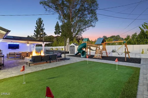 a view of a house with a backyard porch and sitting area