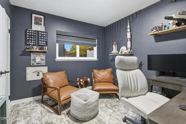 a bedroom with furniture and a lamp