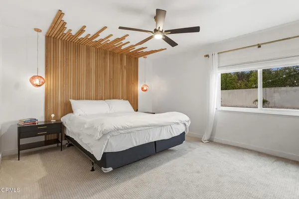 a bedroom with a bed dresser and a window