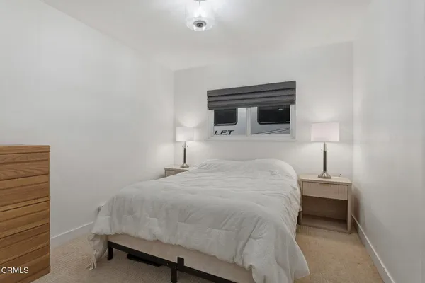 a bedroom with a bed and a night stand
