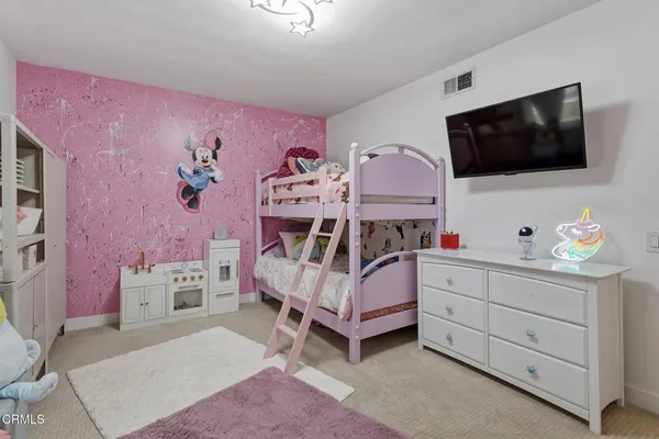 a bedroom with a bed and flat screen tv