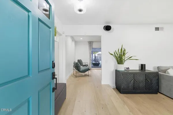 a living room with furniture and a potted plant